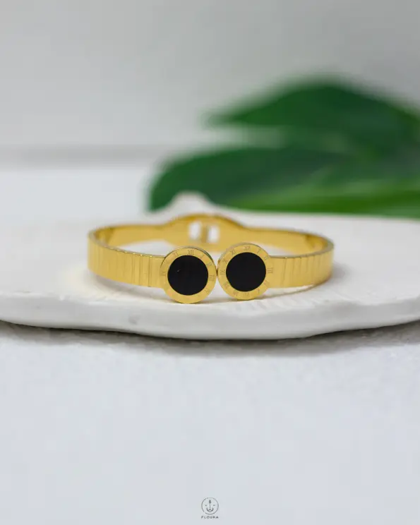 black bulgari gold bracelet