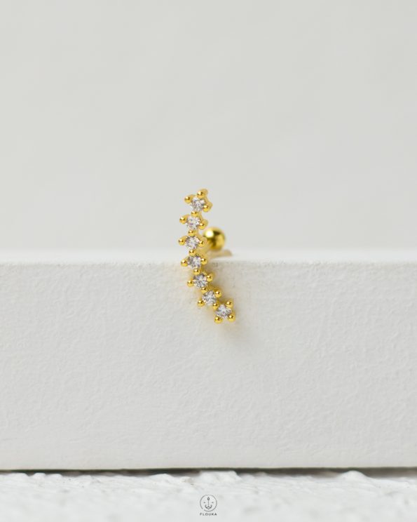 gold strus piercing