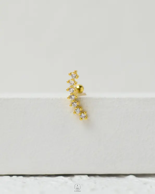 gold strus piercing