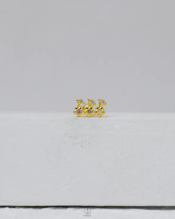 gold strus piercing