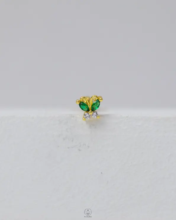green butterfly piercing